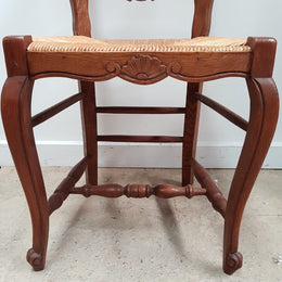 A set of six French Louis XV style, ladder back oak chairs. With finely carved detail and rush seat. In great original condition. Chairs are comfortable and sturdy for everyday use.