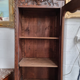 Petite oak armoire display cabinet with a glass door, two drawers at the bottom and three shelves inside. Late 18th Century and amazing detailed decorative carvings. Sourced from France and in good original condition.