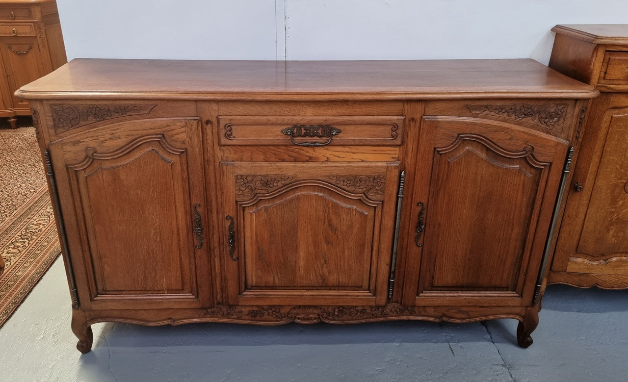 Lovely French Oak three-door sideboard with beautifully carved details and there is also a drawer. In good original detailed condition.