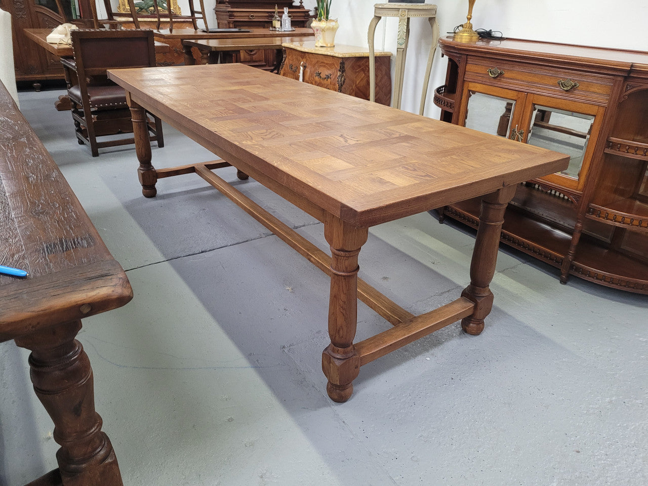 French Oak Refectory dining table with a parquetry top. Sourced from France this table comfortably sits eight to ten. It is in good original detailed condition.