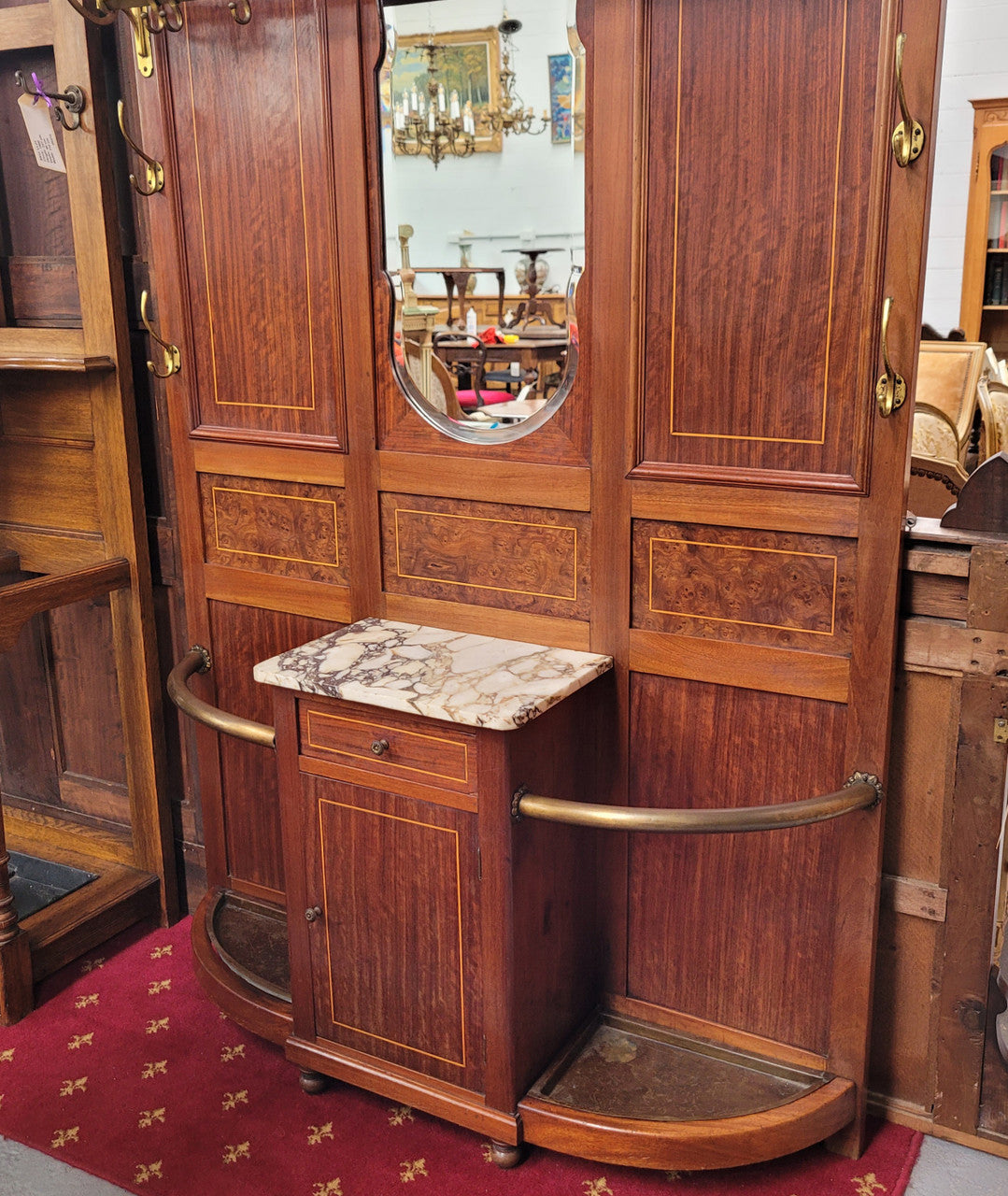 Attractive French Burr Walnut Hallstand. It has a single drawer, cupboard, brass rods, umbrella storage and a marble shelf. It is in good original condition. Please see photos as they form part of the description.