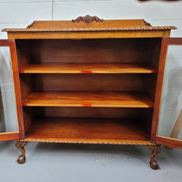 Chippendale style Mahogany two door bookcase. It has bevelled glass doors and two adjustable shelves. It has been sourced locally and is in good original detailed condition.