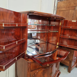 1950’s Chippendale Style Flame Mahogany Four door Bar. The top section has glass shelves and a mirrored pull out tray for storing glasses, decanters & serving etc. It also has a silver presentation plaque to the Mayor of Hawthorn 1958. The bottom section is for storage bottles etc. A stunning and practical piece.