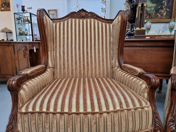 Beautiful pair of Walnut French-style newly upholstered wingback armchairs. They are in very good original detailed condition.