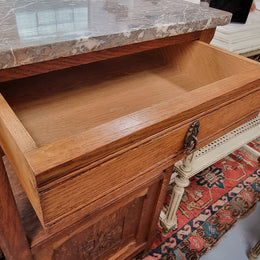 Charming pair of French Oak Arts and Crafts bedsides with shelf, cupboard with carving and marble top.  They have been sourced from France and are in good original detailed condition.