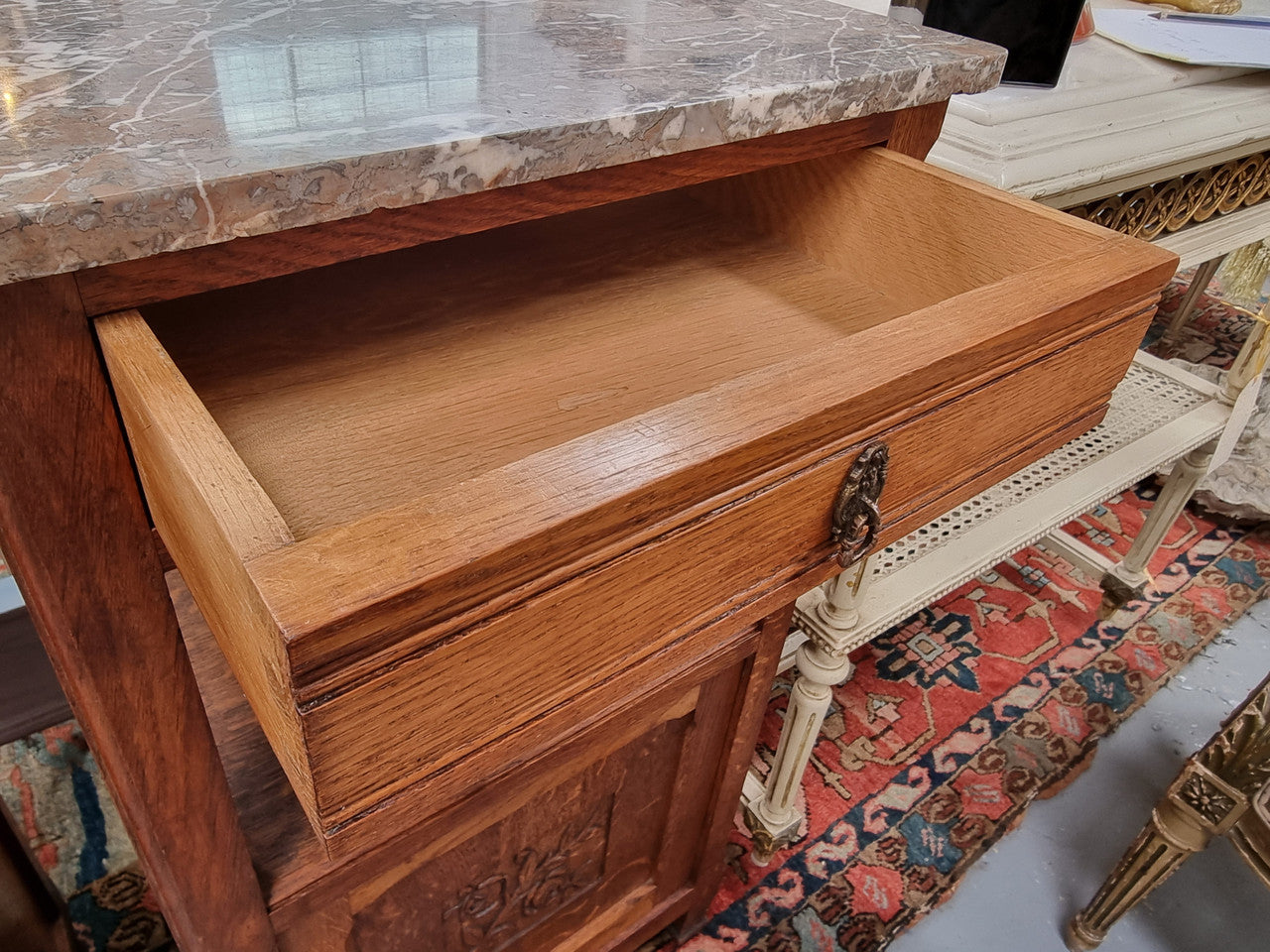 Charming pair of French Oak Arts and Crafts bedsides with shelf, cupboard with carving and marble top.  They have been sourced from France and are in good original detailed condition.