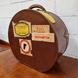 Charming solid leather hatbox with patterned fabric interior and two interior pockets. Interior stamp is for The Mutual Store Melbourne. Bears paper stamps for P&O Cruise Passenger” & “Peninsular  the top and D.M.F. in gold near the handle. Circa: Early 1900’s. 43 cm across and H:21 cm the lid.