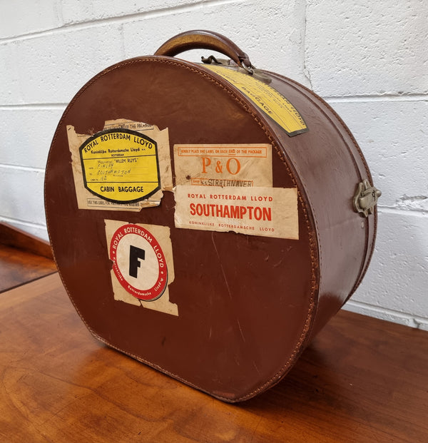 Charming solid leather hatbox with patterned fabric interior and two interior pockets. Interior stamp is for The Mutual Store Melbourne. Bears paper stamps for P&O Cruise Passenger” & “Peninsular  the top and D.M.F. in gold near the handle. Circa: Early 1900’s. 43 cm across and H:21 cm the lid.