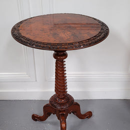 Rare early Victorian Irish Burr Walnut wine table. It has a beautiful carvings and a stunning burr walnut top, on a barley twist column and three shaped legs. It has been sourced locally and is in good original detailed condition. We also have a second table being sold separately which when together make a matched pair.