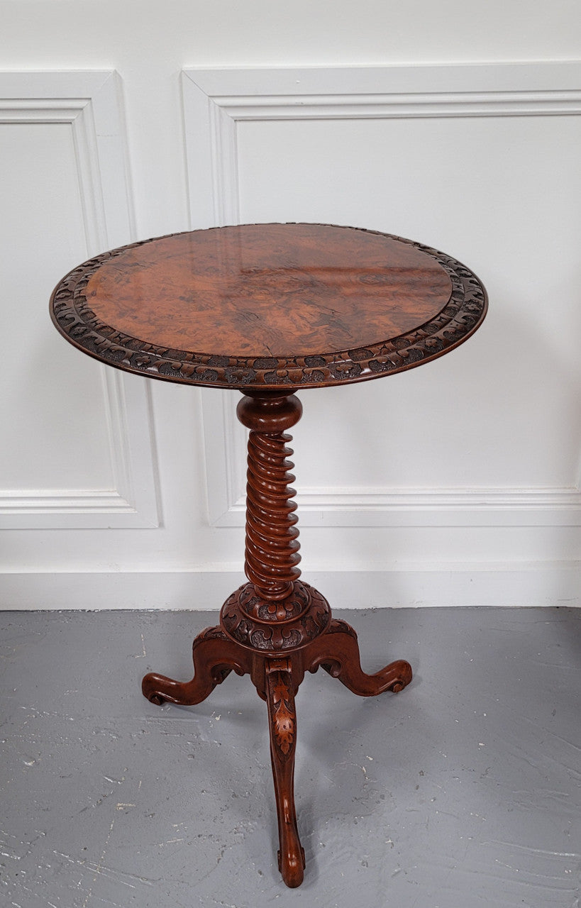 Rare early Victorian Irish Burr Walnut wine table. It has a beautiful carvings and a stunning burr walnut top, on a barley twist column and three shaped legs. It has been sourced locally and is in good original detailed condition. We also have a second table being sold separately which when together make a matched pair.