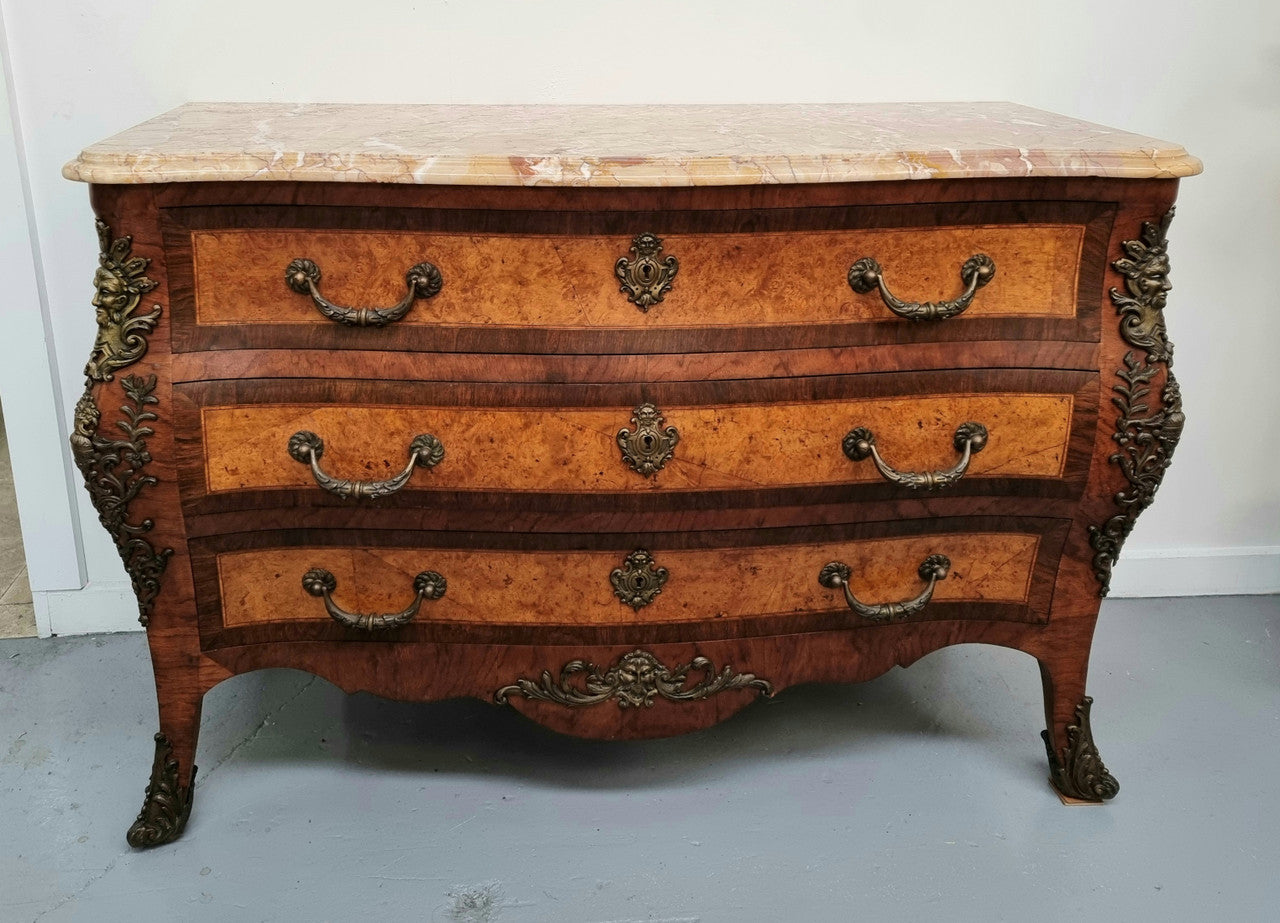 A beautiful French Louis XIV style walnut and burr walnut commode of grand proportions. It has three large drawers and elaborate bronze mounts with a fabulous marble top. In very good original detailed condition.