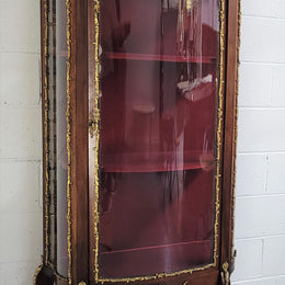 Louis XV style Vitrine with curved glass and red velvet lining. It has two fixed shelves with a marble top and ormolu decoration. In good original detailed condition.