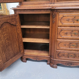 Impressive French Oak Louis 14th Style Display and Sideboard. It has 4 drawers, 2 bottom cupboards with 6 total shelves and 3 display doors with 3 shelves.  In good, detailed condition.