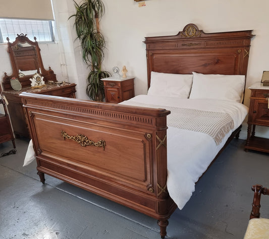 Louis XVI style Mahogany Queen size bed on original castors. This bed has beautiful carved details and and Ormolu mounts in good original detailed condition