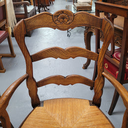 Pair of Louis XV Style Oak framed rush seated carver chairs. They have been sourced from France and in good original detailed condition.