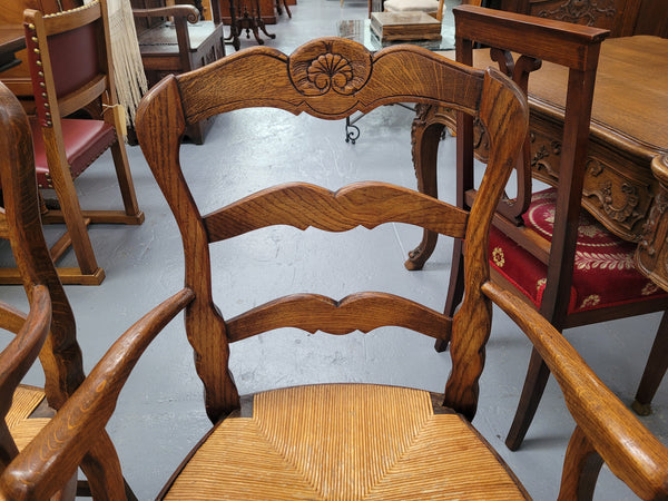 Pair of Louis XV Style Oak framed rush seated carver chairs. They have been sourced from France and in good original detailed condition.