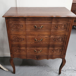 French Oak Louis XV style three drawer commode. It has been sourced from France and has decorative handles and carvings. It is in good original detailed condition.
