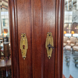 French Louis XVI style mirrored two door armoire/wardrobe. It has plenty of hanging space as well as two drawers at the bottom. In good original detailed condition.