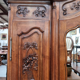 French Walnut Louis XV style three door armoire with 10 fully adjustable shelves in total spread over three sections, two drawers and a mirrored middle door. It has been sourced from France and in good original detailed condition.