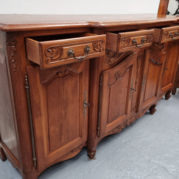 French parquetry top Cherry Wood four-door and four-drawer sideboard. Very decorative carving and is in good original condition.