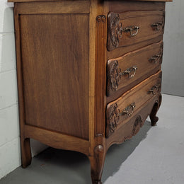 A French Walnut carved three drawer commode with lovely handles and in good original detailed condition.A French Walnut carved three drawer commode with lovely handles and in good original detailed condition.