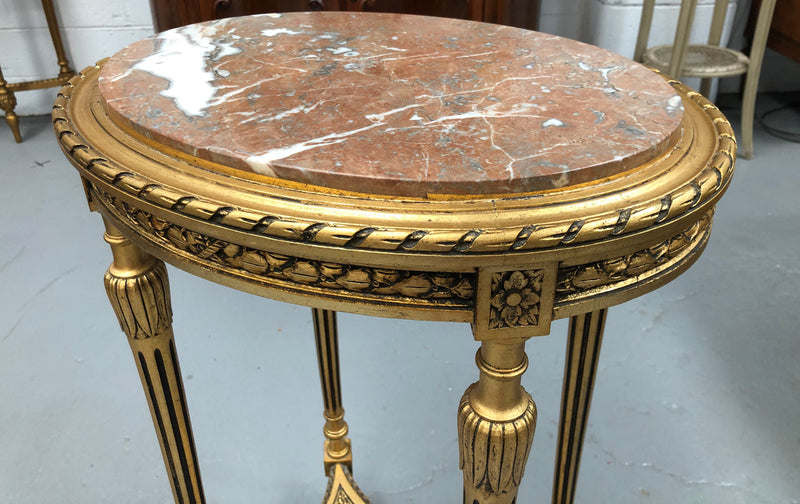 Antique French Louis XVI style gilt, ebonised and marble top side/occasional table. It is Walnut wood that has been gilded over. In good original condition.