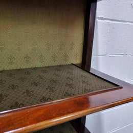 Edwardian Sheraton Revival Mahogany display cabinet with green upholstered  fabric backing and shelving with inlay and two decorative glazed doors.