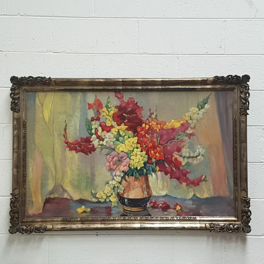 French floral oil on canvas painting, framed in a decorative frame and is in good original condition.