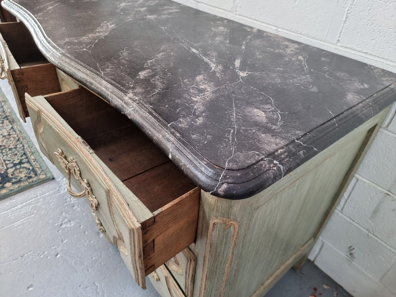 Early 19th Century Louis XIV style faux marble top and painted base commode. It is of large proportions and has four drawers. In good original detailed condition.