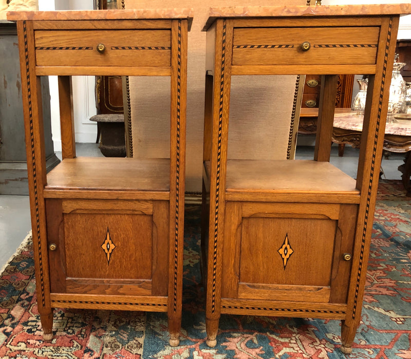 Beautiful pair of French Oak inlaid bedside cabinets with marble tops and a drawer and cupboard for all your storage needs in good original condition.