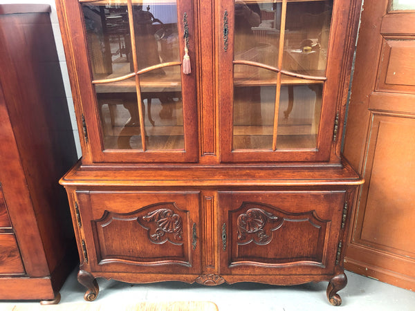 Vintage French Oak two door bookcase/display cabinet with a two door storage cabinet at the bottom. It is in good original condition.