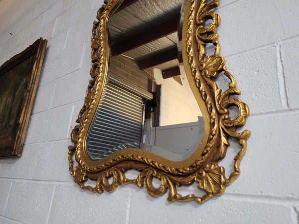 Large Vintage Italian carved wood gilt mirror. It has a beautiful bevelled mirror and has been sourced from France. It is in good original condition.
