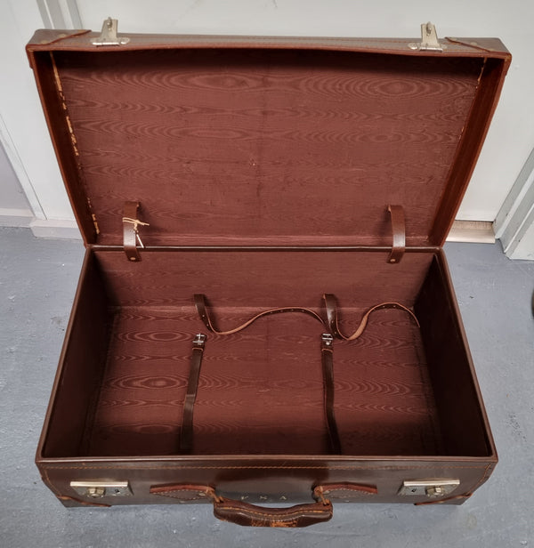 Impressive solid leather suitcase, moire fabric lined with leather straps to hold contents. Displays gold initials F.S.A near handle. With key. Please view photos as they help form part of the description.