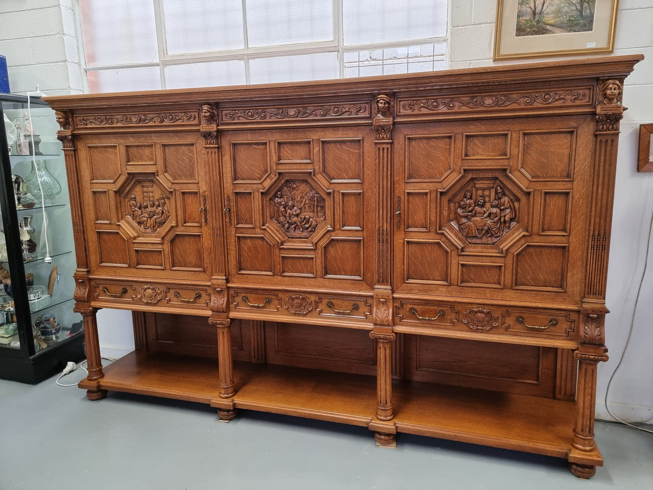 Impressive and grand French Oak Renaissance style sideboard. Beautifully detailed carvings and plenty of storage with three very large cupboards with a total of eight adjustable shelves along with three large drawers. It has been sourced from France and is in very good original detailed condition.