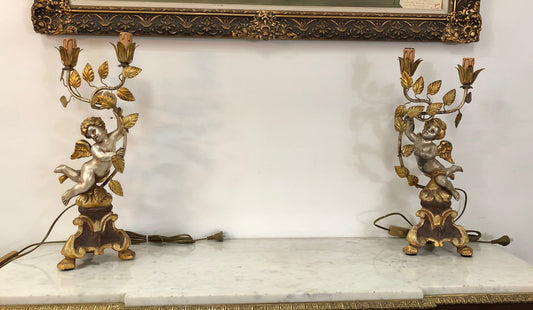 Pair of charming carved wooden cherub two light lamps. Finished in silver and gilt. Completely rewired to Australian Standard.