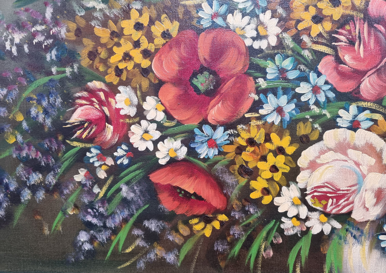 Sourced from France a stunning colorful floral oil painting on canvas. It is in a decorative gilt frame and is signed. It is in good original detailed condition.