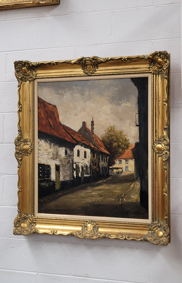 Dutch signed oil on canvas depicting village street in a beautiful gilt frame. It is in good original detailed condition and has been sourced from France.