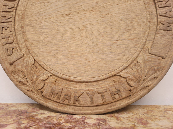 Antique circular Oak bread board carved with “Manners Makyth Man” and the arms of Winchester College England. It is in good original condition, please view photos as they help form part of the description.