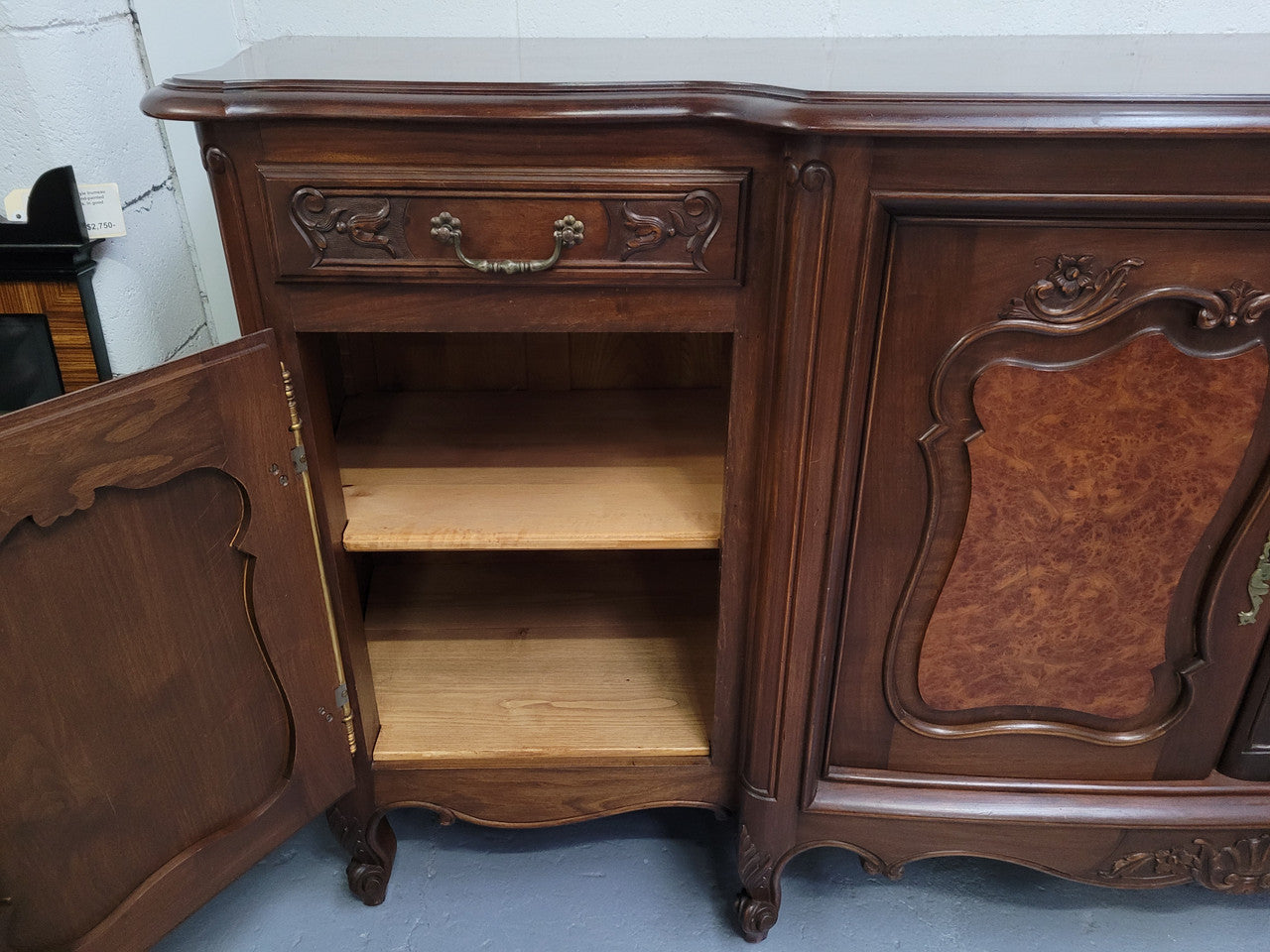 Fabulous Louis XV style French Walnut and Burr Walnut four door sideboard. Each door panel has beautiful Burr Walnut panels and open up to an adjustable shelf. Beautiful handles and two drawers for added storage. In good original detailed condition.