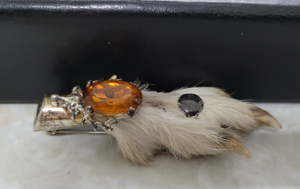 Scottish Grouse foot with Amber coloured glass. In good original condition, please view photos as they help form part of the description.