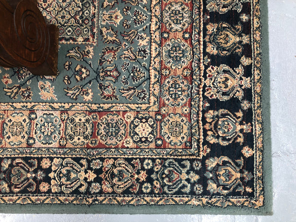 A beautiful coloured Turkish Rug with shades of green, teal, navy and rust in good condition.