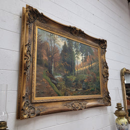 Large signed oil on canvas depicting a river stream in autumn framed in a stunning gilt frame. Sourced from France and is in good original detailed condition.