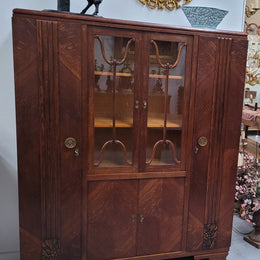 Stylish French Art Deco Oak bookcase with heaps of storage space and shelves. Middle section has two glass display doors. In good original detailed condition.