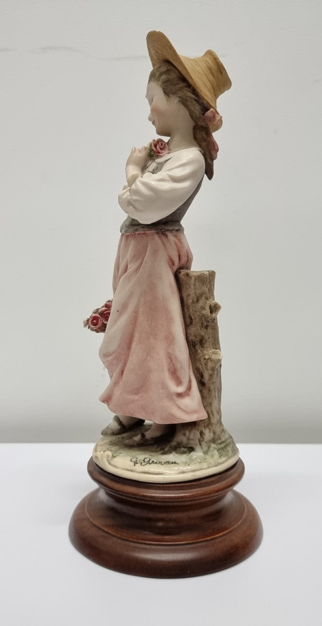 Lovely Italian figurine of girl carrying basket with flowers, figurine is on a wooden base. It is signed Giuseppe Armani and 1982 FLORENCE. In good original condition.  Please view photos as they form part of the description.