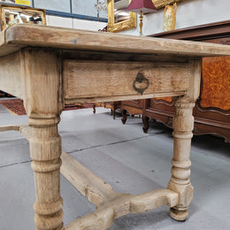 French stripped Oak pedestal stretcher base Farmhouse table with two drawers on either side of table. Features raw wood that could be used as is for a distressed look, or finished and waxed for a more refined look.