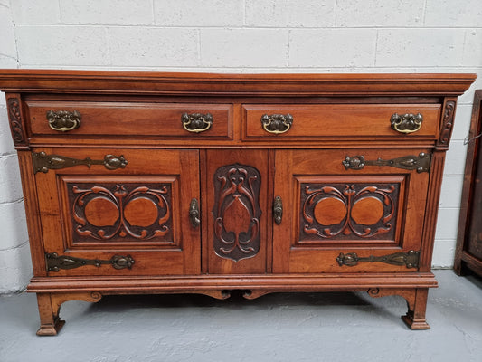 Beautiful decorative Art Nouveau sideboard with lovely handles and beautiful carved detailing. It is in good original detailed condition.