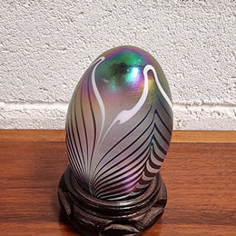 Iridescent glass egg shaped paper weight, on small wooden chinese stand. In good original condition. Please see photos as they form part of the description.