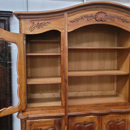 Magnificent French Walnut two-body four door display cabinet. Heaps of storage space with four glass doors at the top with shelves and four solid doors below also with shelving. It has been sourced from France and comes with a key for each door and all are lockable. In good original detailed condition.