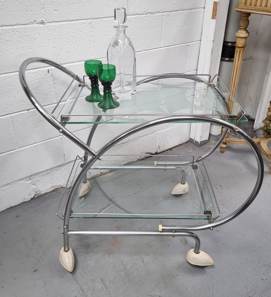Stylish Art Deco chrome & frosted glass drinks trolley. Bakelite guards on the wheels. It is in good original condition and has been sourced locally.
