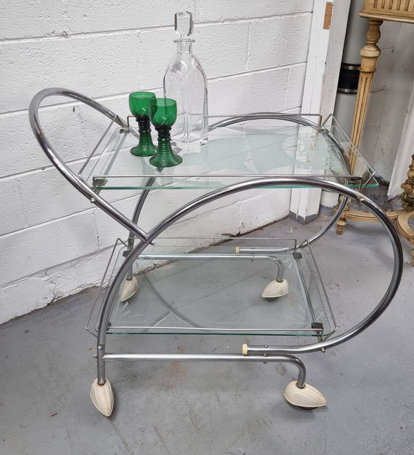 Stylish Art Deco chrome & frosted glass drinks trolley. Bakelite guards on the wheels. It is in good original condition and has been sourced locally.